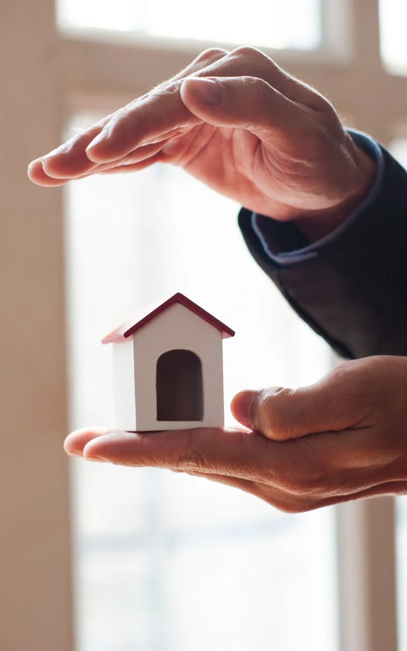 a-house-statue-between-hands